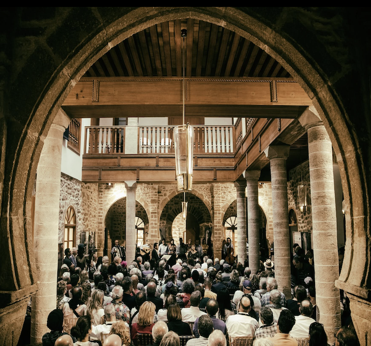 Audience attending an Andalusian music concert in a historic Essaouira courtyard